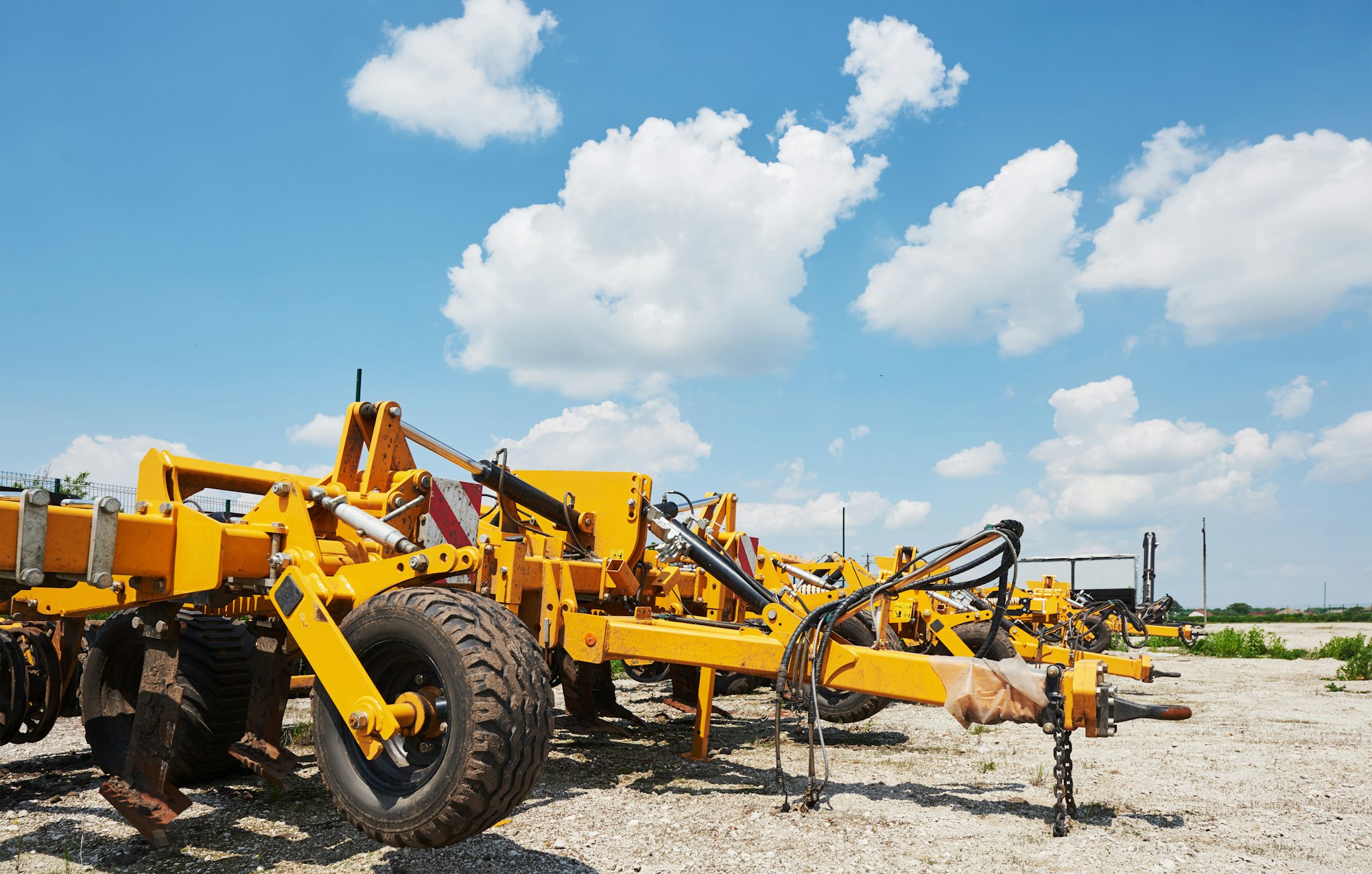 Close up of seeder attached to tractor in field. Agricultural machinery for spring works sowing