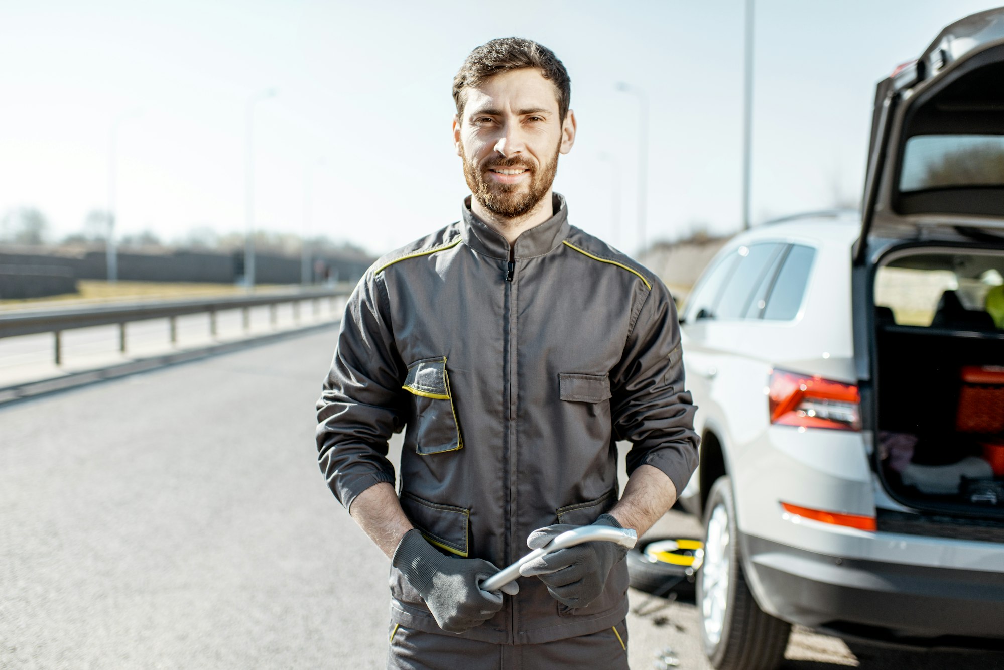 Road assistance worker near the car on the highway